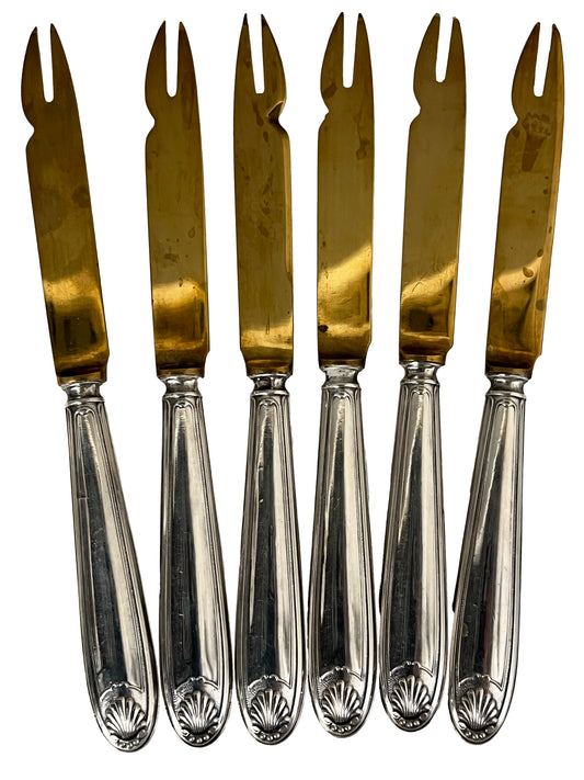 Argent fourré and gilt metal melon knives and forks decorated with a shell